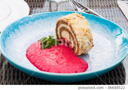 carrot roll with raspberry mousse in a restaurant carrot roll with raspberry mousse in a restaurant 86688522