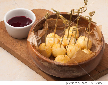 cheese balls fries with berry sauce in the restaurant cheese balls fries with berry sauce in the restaurant 86688535