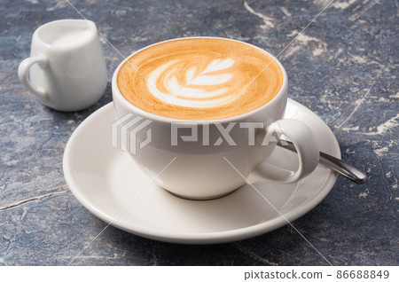 medium cappuccino Cup on a grey background 86688849
