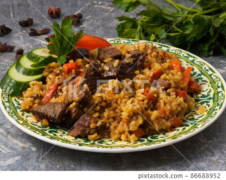 pilaf with beef on a gray background. Close up pilaf with beef on a gray background. Close up 86688952