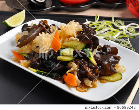 salad of white and black muer mushrooms on a white plate salad of white and black muer mushrooms on a white plate 86689248
