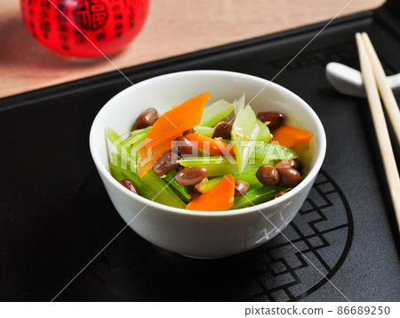 Chinese salad with soaked peanuts in a white bowl on a black background Chinese salad with soaked peanuts in a white bowl on a black background 86689250