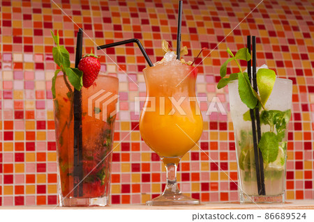 non-alcoholic cocktails with ice on a colored background 86689524