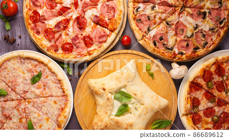 assorted pizzas on a wooden table. top view assorted pizzas on a wooden table. top view 86689612
