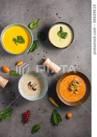 four different soups decorated with herbs. Top view four different soups decorated with herbs. Top view 86689619