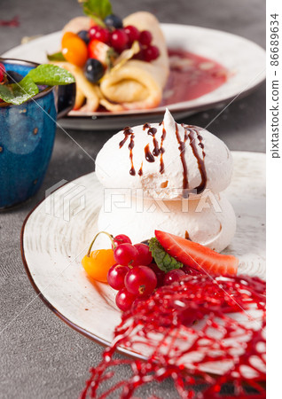 meringue decorated with berries, close-up. Concept 86689634
