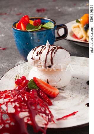 meringue decorated with berries, close-up. Concept meringue decorated with berries, close-up. Concept 86689635