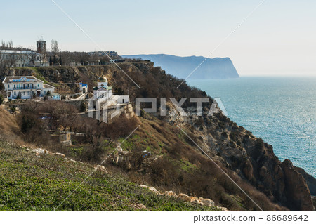 View of Crimean rugged rocky shore with Saint George Monastery in spring. Sevastopol, Crimea 86689642