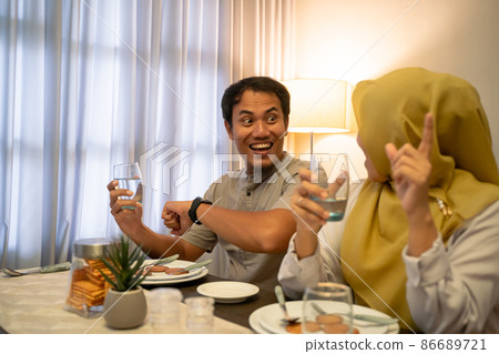 excited couple having iftar dinner time together excited couple having iftar dinner time together 86689721