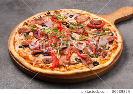 pizza with bacon and hunting sausages on a gray background 86689839