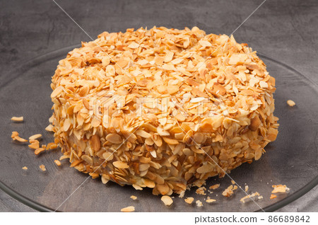 a whole cake with nuts on a gray background a whole cake with nuts on a gray background 86689842