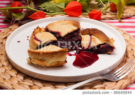 juicy shortbread with cherries on a white plate juicy shortbread with cherries on a white plate 86689844