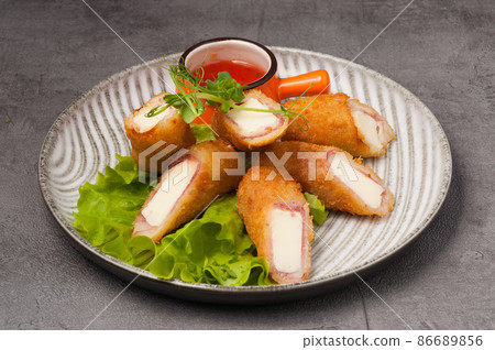 deep-fried ham and cheese rolls with hot sauce deep-fried ham and cheese rolls with hot sauce 86689856