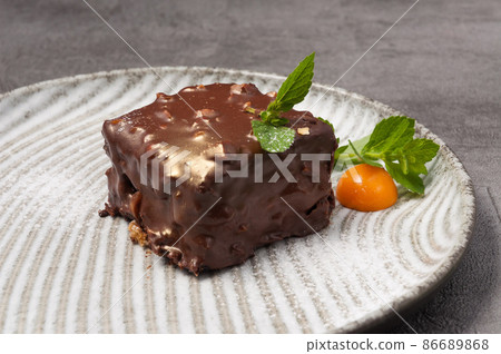 a piece of chocolate cake with nuts. close up a piece of chocolate cake with nuts. close up 86689868
