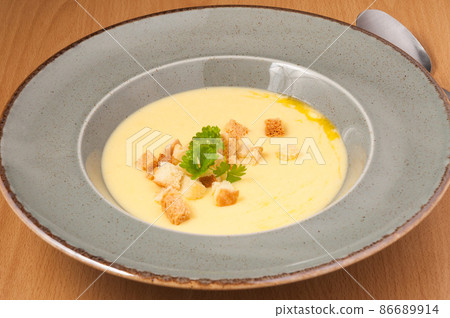 mashed soup with croutons decorated with herbs. close up 86689914