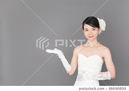 A woman in a wedding dress guided by hand 86690809