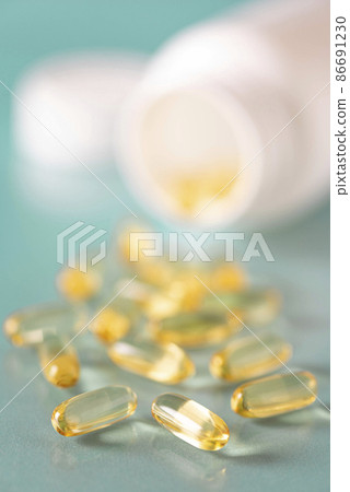 soft gelatin capsules with fish oil in a white bottle, close-up 86691230