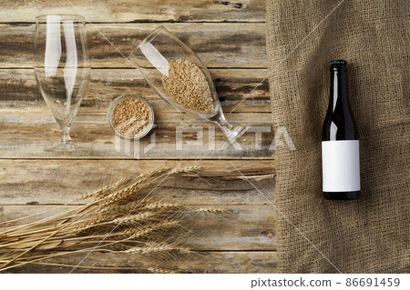 A bottle of beer and grain. Top view. Free space for text. A bottle of beer and grain. Top view. Free space for text. 86691459