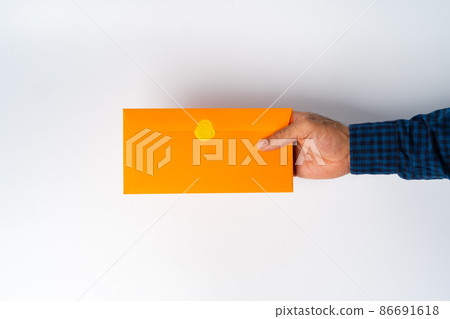 Male hand holding closed envelope above the white surface Male hand holding closed envelope above the white surface 86691618