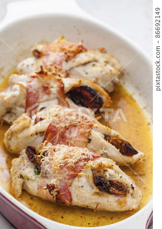 chicken rolls stuffed with dry tomatoes in bacon 86692149