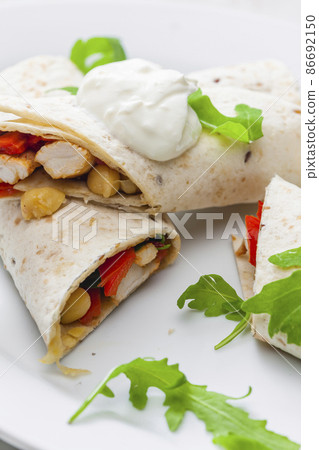tortilla filled with chicken meat, red pepper and beans tortilla filled with chicken meat, red pepper and beans 86692150