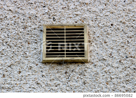 Ventilation Duct Cover on a Roughcast House Rear Wall 86695082