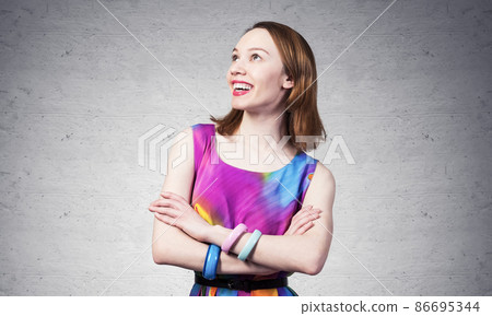 Smiling woman standing with folded arms 86695344