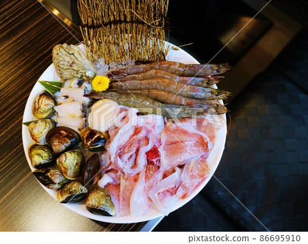 Variety of freshly cut seafood on white plate 86695910