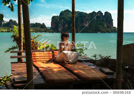 Beautiful girl resting on the sea. Lonely girl resting on the island. The girl on the Paradise coast. The girl on the Islands. A woman on a luxurious shore. Asian Islands. Holidays in Thailand 86696168