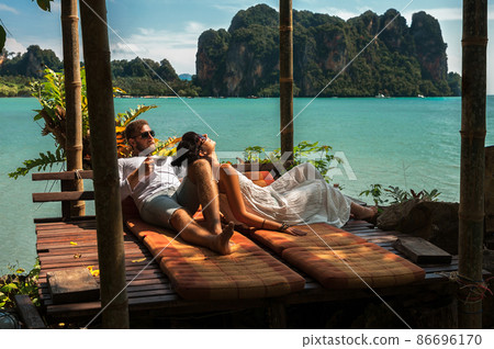 Loving couple resting in Asia. A young couple travels to exotic countries. Man and woman at the resort. Couple resting in Thailand. Honeymoon trip. Wedding travel. Man and woman on the Islands 86696170