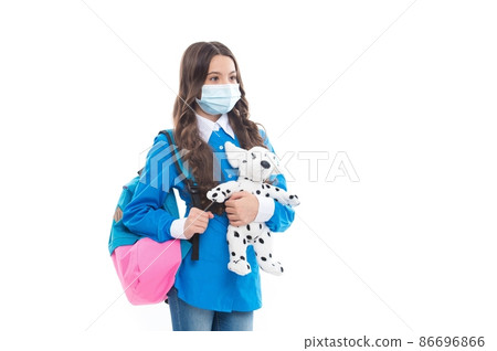 Safe return to school. Kid wear mask holding toy dog. Personal hygiene. Sanitation and hygiene Safe return to school. Kid wear mask holding toy dog. Personal hygiene. Sanitation and hygiene 86696866