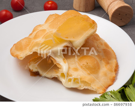 cheburek with cheese. an unusual combination of classic dishes cheburek with cheese. an unusual combination of classic dishes 86697938