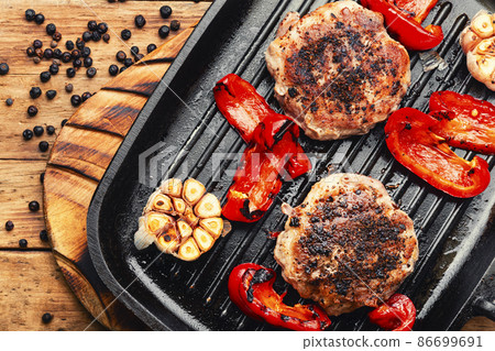 Fried beefsteak in bacon on grill pan 86699691