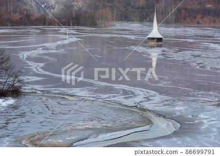 Church flooded and submerged by toxic waste waters from a copper and gold mine. Geamana, Rosia Montana, Romania 86699791