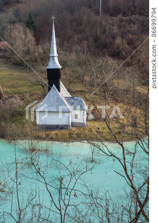 Toxic waste waters from a copper and gold mine submerge village. Abandoned orthodox church on lakeside Toxic waste waters from a copper and gold mine submerge village. Abandoned orthodox church on lakeside 86699794