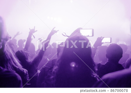Raised arms holding smart phones to recording a live concert 86700078