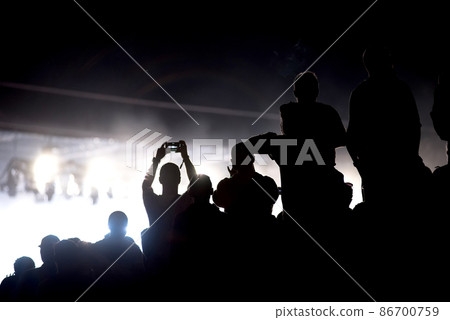 Silhouette of concert crowd and stage lights 86700759