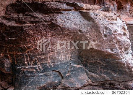 Nabatean and Thamudic inscriptions on rock in Wadi Rum desert 86702204