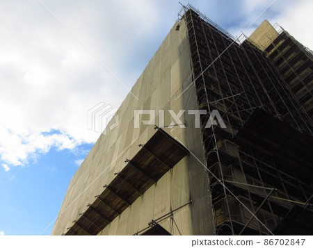 Municipal Imafukuminami Housing Building No. 4 with scaffolding and exterior wall construction under construction 86702847