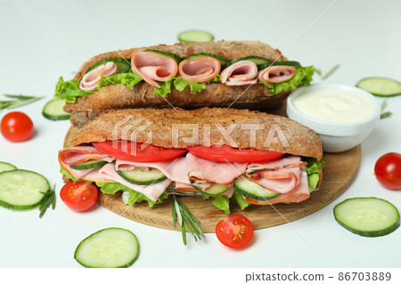 Concept of tasty eating with ciabatta sandwiches on white background Concept of tasty eating with ciabatta sandwiches on white background 86703889