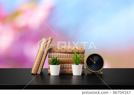 Stack of books on wooden table against blurred background Stack of books on wooden table against blurred background 86704167