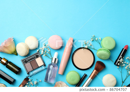 Female accessories and macaroons on blue background 86704707