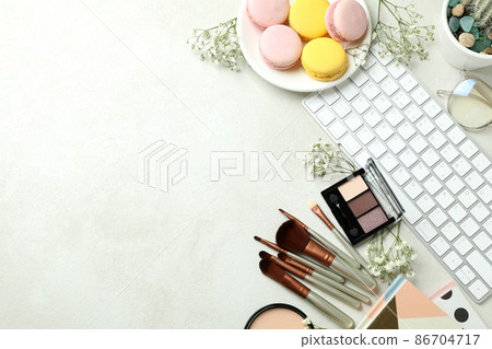 Female accessories and macaroons on white textured background 86704717