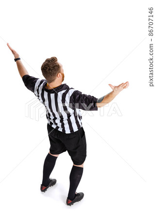 Back view. Full-length portrait of soccer or football referee wearing field judge uniform isolated on white studio background. Concept of sport, rules, competitions, rights, ad, sales. 86707146