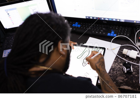 Man drawing on a tablet. Rear view. Selective focus. 86707181