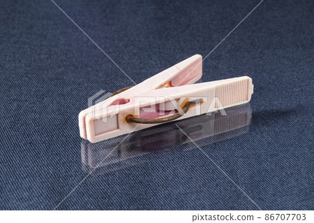 An old clothespin is lying on the table 86707703