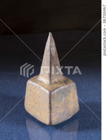 An old anvil for punching a scythe on a table with a reflection An old anvil for punching a scythe on a table with a reflection 86708467