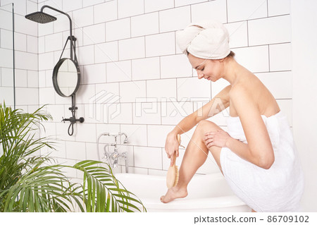 Bathroom skin care. Body brush routine. Woman peeling. Female scrub 86709102