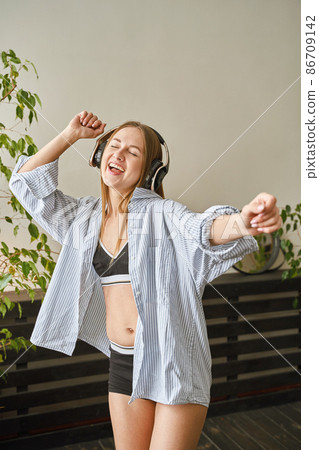 Young woman sing at home. House lyrics dance. Funny song. Independent portrait Young woman sing at home. House lyrics dance. Funny song. Independent portrait 86709142
