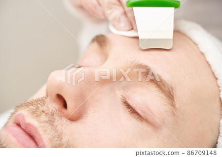 Ultrasound cosmetology scrubber. Face cavitation procedure. Salon skincare 86709148